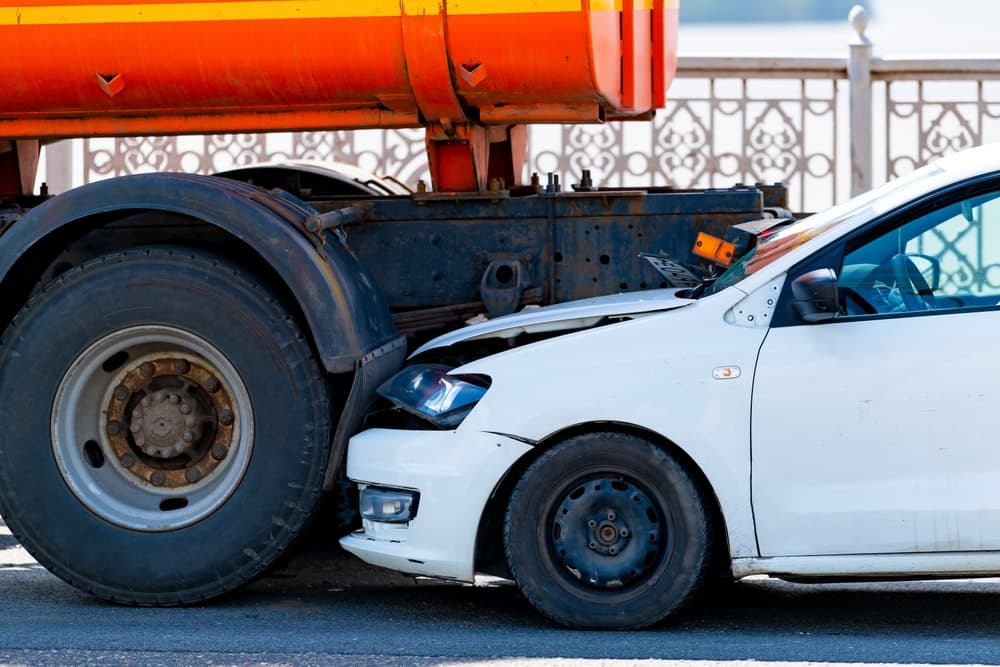 Accident involving two cars on the road, a collision with a truck in rear end.