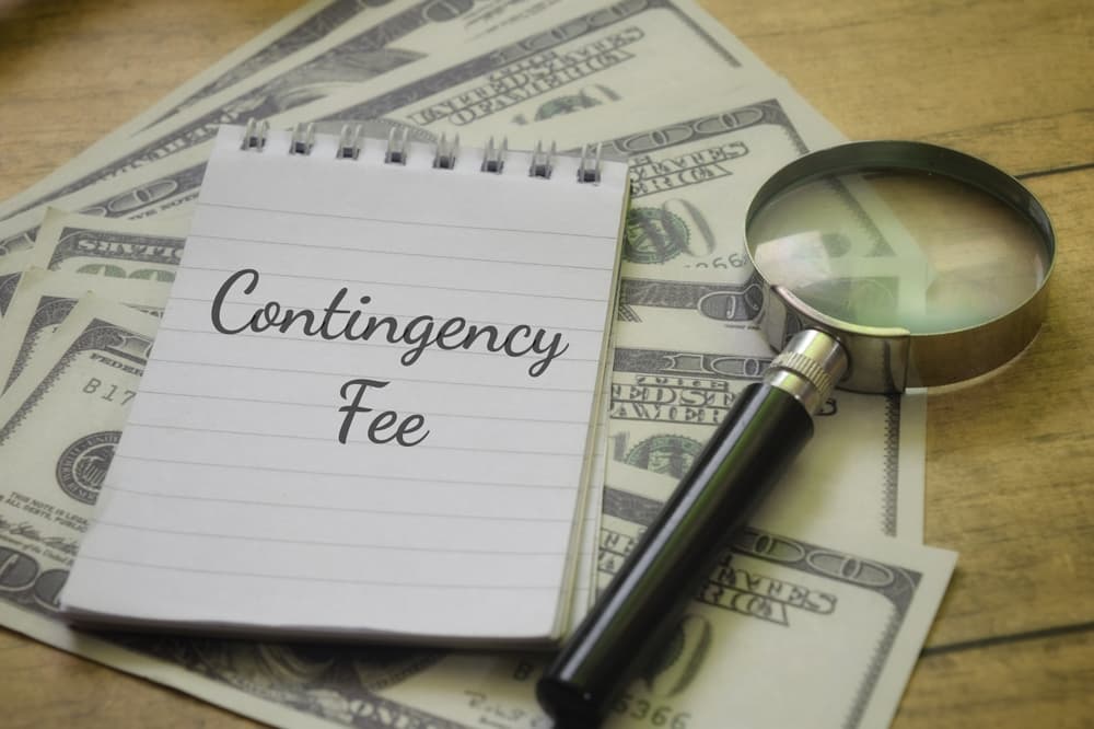 Contingency Fee wording with magnifying glass and money