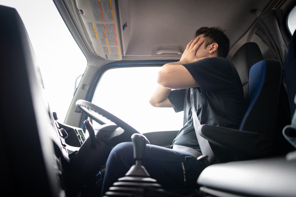 The truck driver is crying after an accident with another vehicle.






