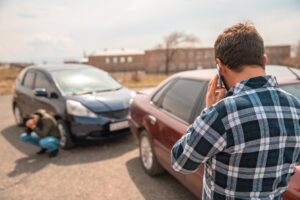 Driver involved in a car accident making a phone call to report the incident to the police